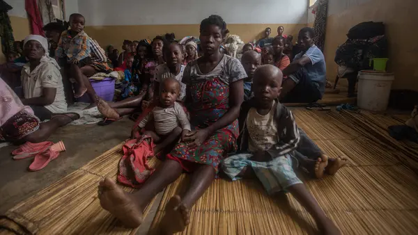 A mother and her two children shelter in a primary school in central Mozambique after they lost their home to Cyclone Freddy.