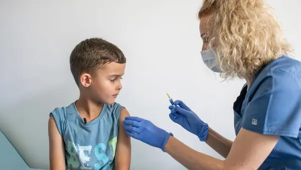 Mykyta, 6, who escaped the war in Ukraine with his family, receives his immunizations at the UNIMED medical center in Krakow, Poland.