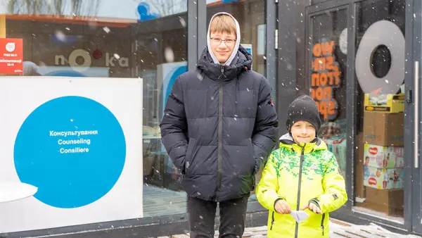 Maxim, 12, and Nazar, 6, stand outside the Siret Blue Dot center at the Romanian border on March 10, 2022, after fleeing Ukraine with their mothers. 