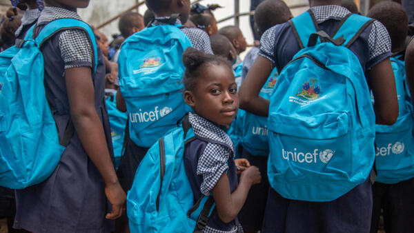 Students Dame Marie school in Grand'Anse, Haiti, carry UNICEF backpacks containing school supplies.