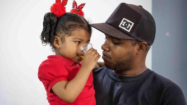 A little girl and her dad attend a UNICEF-supported early childhood development program in San Agustin, Caracas, Venezuela, on March 14, 2023.