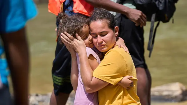 In Lajas Blancas, Darién, Panama in February 2023, a mother and child are reunited after becoming separated in the Darién jungle, one of the world's most dangerous migrant routes.