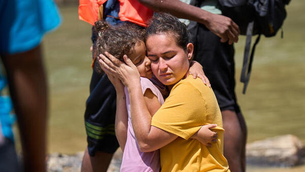 In Lajas Blancas, Darién, Panama in February 2023, a mother and child are reunited after becoming separated in the Darién jungle, one of the world's most dangerous migrant routes.