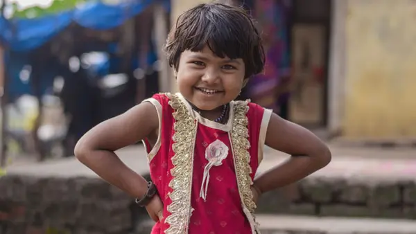 Bharti Raju, 5, poses for photograph outside her house at Shirasgaon Mandap village in Jalna, Maharashtra on Sunday, 19, Oct. 2020.