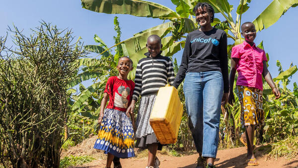 UNICEF Goodwill Ambasador Vanessa Nakate walks with (from left) Bonette, Graciella and Adele in Kigarama Sector, Kirehe District, Eastern Province of Rwanda. 