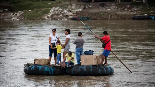 In Ciudad Hidalgo, Chiapas, Mexico, a makeshift raft is used to informally move people and products across the Suchiate River between Ciudad Hidalgo, Chiapas, Mexico and Ciudad Tecún Umán, Guatemala, on Oct. 12, 2022