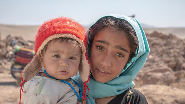 On Oct.10, 2023, 10-year-old Zari holds her brother Marv, 8 months old, in front of their house, which collapsed during an earthquake that hit Zindajan district, Herat Province, Afghanistan on Oct. 7.