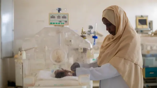 Sudan Auatf Mater Jaber, a pediatric nurse at UNICEF-supported Wad Madani Children's Hospital in Wad Madani, Gezira State, Sudan, tends to a sick baby in the neonatal unit. 