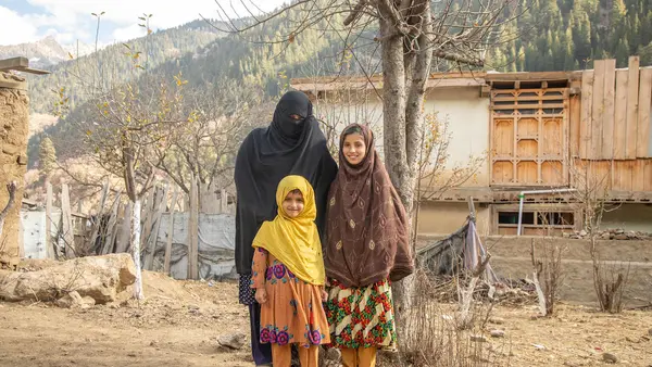 Saeed Khanum stands with two of her six daughters in rural Afghanistan. 