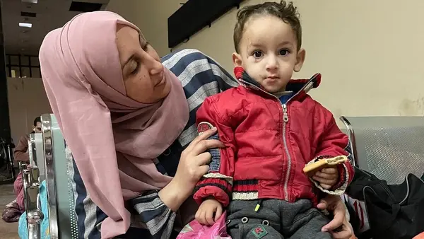 On Jan. 10, 2024, Mageda and her 1-year-old son, Sahad, wait at the Rafah Crossing, seeking authorization to exit the Gaza Strip for medical treatment.