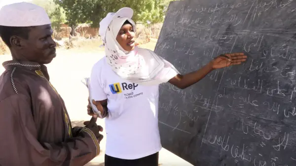 Sudanese refugee Mouwahib Mahamat Adam, 23, teaches literacy classes to local community members in Chad. 