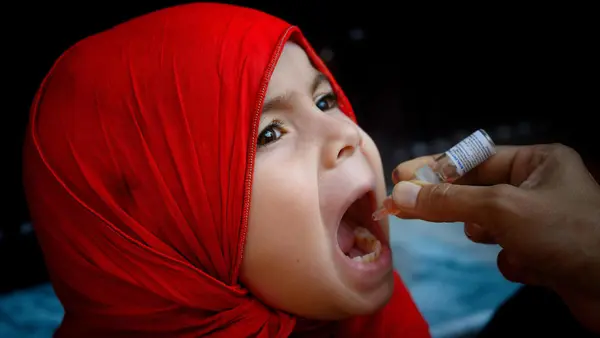 A girl receives the polio vaccine in Rawalpindi, Pakistan.