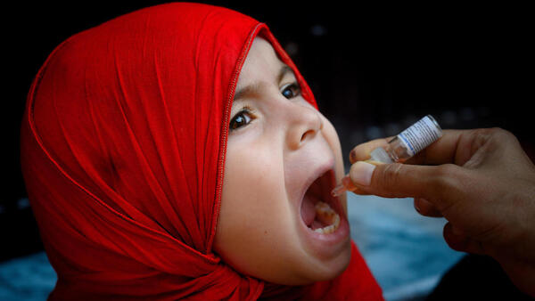 A girl receives the polio vaccine in Rawalpindi, Pakistan.