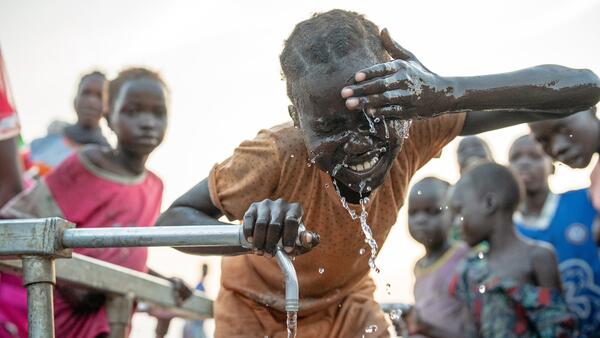 Child washing at the water pipe