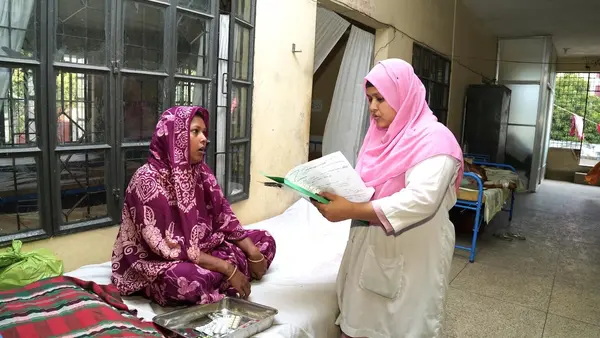 Razia Sultana Tania, a midwife in rural Bangladesh with specialized training supported by UNICEF, consults with a patient.