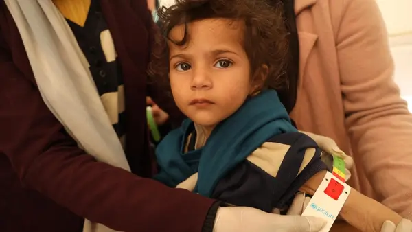 In the Gaza Strip on Feb. 15, 2024, a UNICEF-trained screener measures 2-year-old Leen's mid-upper arm circumference to diagnose severe acute malnutrition.