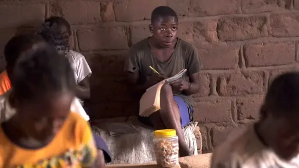 Delphin of Kampyempye village, Tanganyika province, eastern DRC, is back at school and studying hard after having been displaced by conflict.