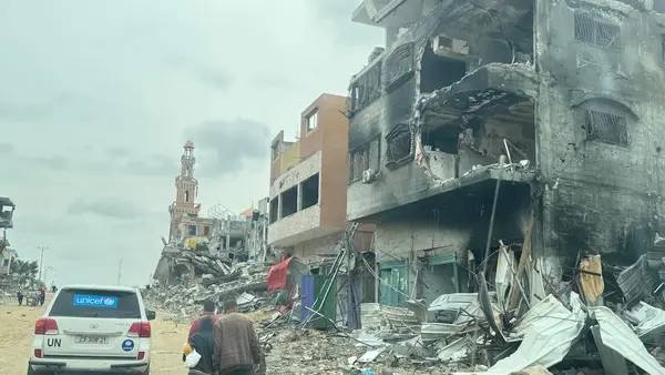 On March 19, 2024, following the recent escalation of violence in Khan Younis, southern Gaza Strip, pedestrians and a UNICEF-marked vehicle travel on a road impacted by the conflict.