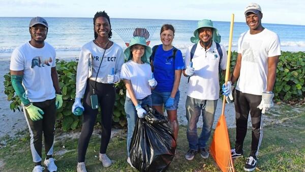 UNICEF Youth Advocate Maria, center, with fellow climate activists, led an environmental clean-up in Oistins, a fishing town in Barbados, in March 2024. 