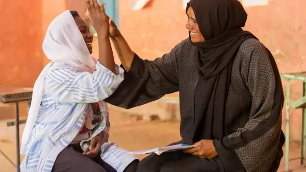 Walaa, 15, meets with Noha, a counselor at the UNICEF-supported Alshargia safe learning space in Kassala State, Sudan.