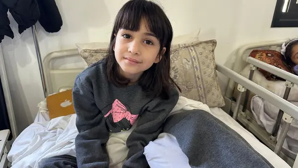 On April 7, 2024, 9-year-old Raghad sits up in bed at the Rafah Indonesian Field Hospital in southern Gaza, where UNICEF and its partner Tamer conduct Mental Health and Psychosocial Support (MHPSS) sessions for children injured in the conflict. 