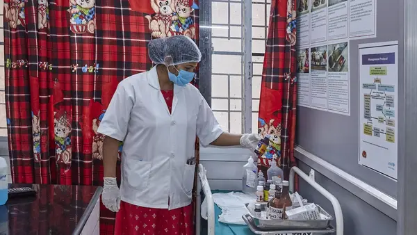 A health care worker follows compliance for labeling medicines at District Combined Hospital in Lodhi, Sonebhadra, Uttar Pradesh, India.