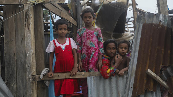 Taieba, 8, Mim, 8, Jannatul, 13, and Shahadat, 3, stand among what remains of their home in Patuakhali, Bangladesh, which was destroyed by Cyclone Remal.