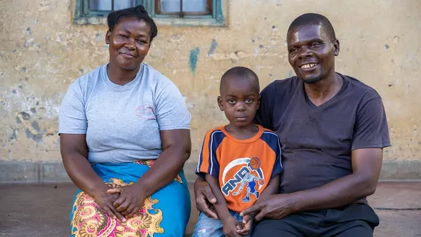 On Jan. 31, 2024, a family sit on the porch of their house in Lilongwe District, Malawi. 