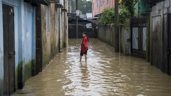 A girl stands in a flooded street in Sylhet, North-East Bangladesh.