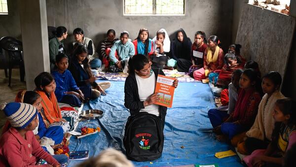 A peer facilitator displays materials from the Rupantaran tool kit provided by UNICEF to a class of adolescent girls in Nepal’s Maharajganj Municipality. 