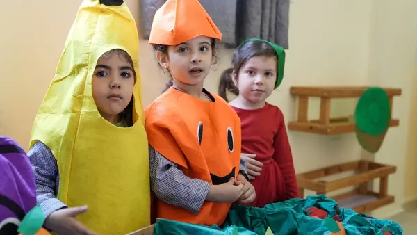 Young children learn about good nutrition at a UNICEF-supported learning space in Lebanon.