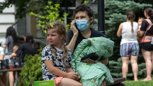 OnJuly 8, 2024 in Kyiv, a child sits on a bench and cries as rescuers, hospital staff and volunteers clear rubble and search for people trapped under debris after an attack that hit Okhmatdyt Hospital, Ukraine's largest children's medical center.