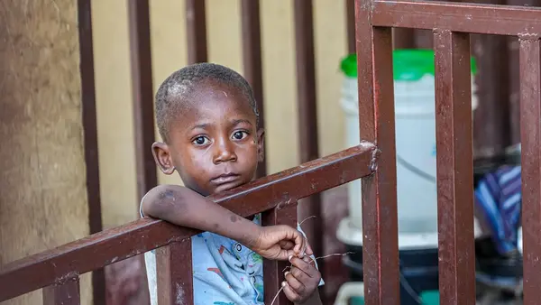 Displaced by violence, a boy stands in a hallway of a school being used as an emergency shelter in Port-au-Prince, Haiti.