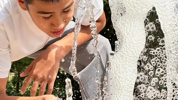 Khurshed, 13, stays cool on his way home at the fountain at the Spartak park when temperatures reach 35 degrees Celsius in Dushanbe, Tajikistan, in early July., 2024