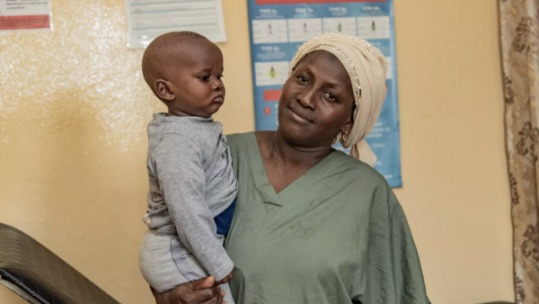 Aissata Dambélé, a nurse, holds 9-month-old Mohamed at Bernay-Fotoba health center in the Matoto commune of Conakry, Guinea.