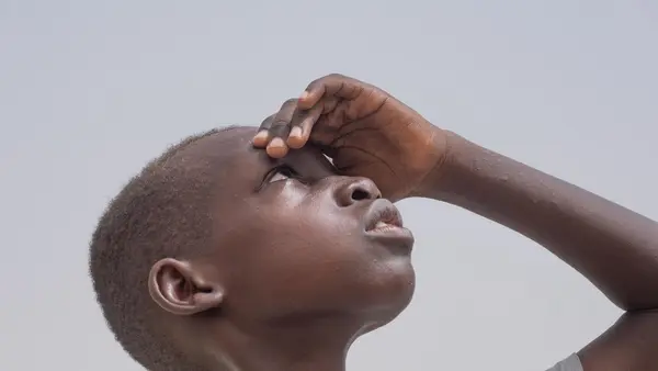Ali Taha Yousif, 10 years, sweats under the scotching sun in Sudan.