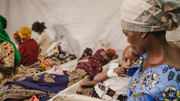 A mother holds her child suffering from mpox at the mpox isolation unit of the UNICEF-supported Kavumu Hospital in South Kivu province, Democratic Republic of the Congo (DRC), on July 23, 2024