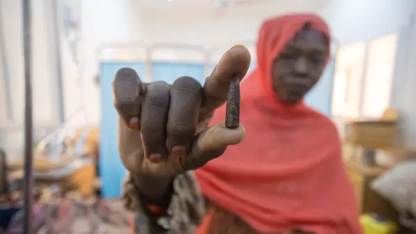 Samah holds the bullet that was removed from her 8-year-old daughter Fatima's head at UNICEF-supported Aljekaika hospital in northern Sudan..
