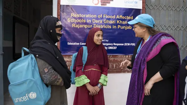 Muqadas, 12, and her mother, Salma, 35, talk with a UNICEF staff member at the ALP center in Dera Ghazi Khan, Punjab, Pakistan.