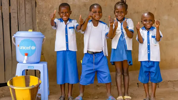 Students at Ecole Primaire Ilako in Mbandaka, Democratic Republic of the Congo, stand outside their classroom after washing their hands. UNICEF installed handwashing stations at the school to help students protect themselves from Ebola.