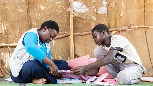 Samer, 16, with help from UNICEF, makes reusable sanitary pads at his home in a displacement camp in Atbara, River Nile State, Sudan.
