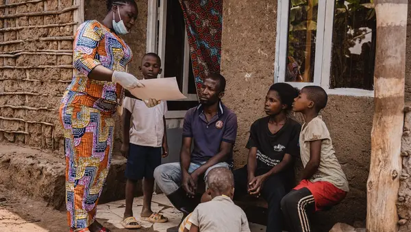 Mwamini Badesire, a community leader and UNICEF-supported community outreach worker, raises awareness about mpox symptoms and prevention measures with the Amani family in Chireja village, South Kivu province, DR Congo, on Sept. 13, 2024.
