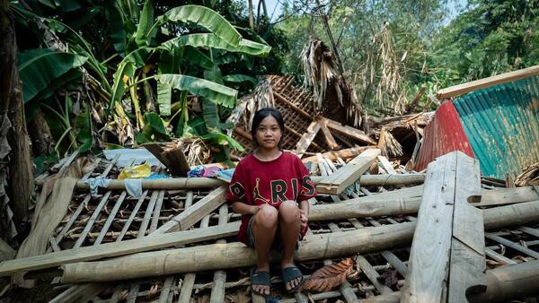 On Sept. 26, 2024, Hoang Thi Tuyet Nhung, 13, sits on the ruins of a house destroyed by a landslide caused by Typhoon Yagi in Thuong village, Yen Bai province, Vietnam.