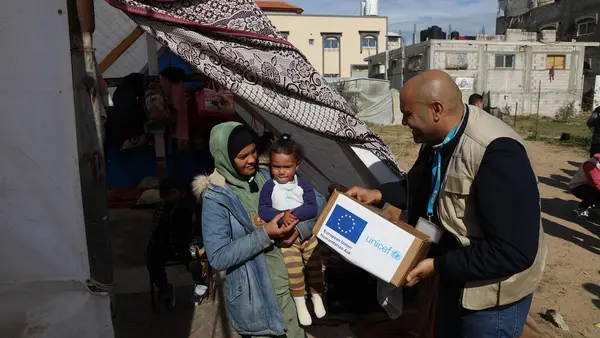 UNICEF Staff members distribute warm clothing to the IDP community in Rafah, southern Gaza Strip.