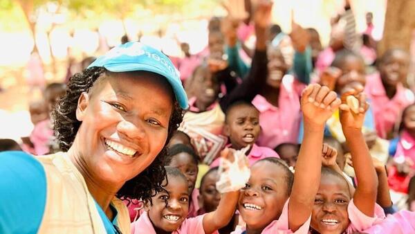 Students celebrate the K.I.N.D. Fund's delivery of new desks to their school in Mzimba District, Malawi on Oct. 23, 2024. 