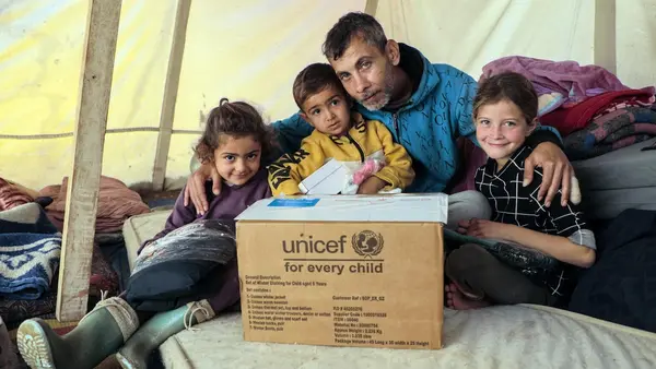 UNICEF and partners bring warmth to children in Khan Younis, Gaza Strip by distributing winter clothes to families in Algeria Camp and Al Amal Camp.