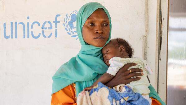 Qabil holds her 3-month-old son at the UNICEF-supported health clinic in Alkarama, Kassala state, Sudan.