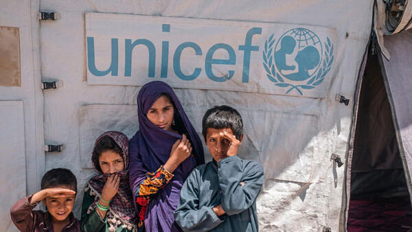 Children standing in front of a UNICEF tent