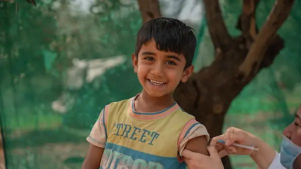 On April 22, 2024, Rayyan receives an MMR vaccine from a UNICEF-supported health worker in the informal tented settlement in Jarish, north Jordan where he lives. 