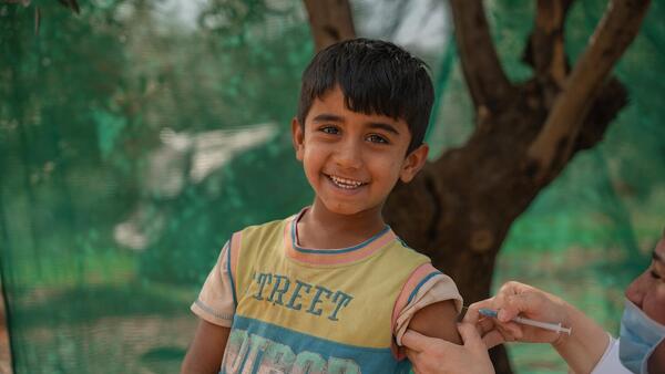 On April 22, 2024, Rayyan receives an MMR vaccine from a UNICEF-supported health worker in the informal tented settlement in Jarish, north Jordan where he lives. 